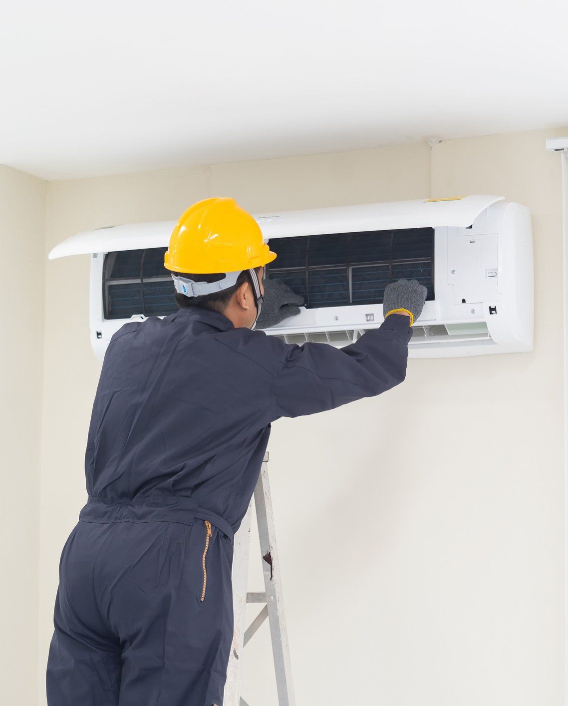 Technician Repairing the Air Conditioner — Summerville, SC — Carolina Air Care Technician Repairing the Air Conditioner — Summerville, SC — Carolina Air Care