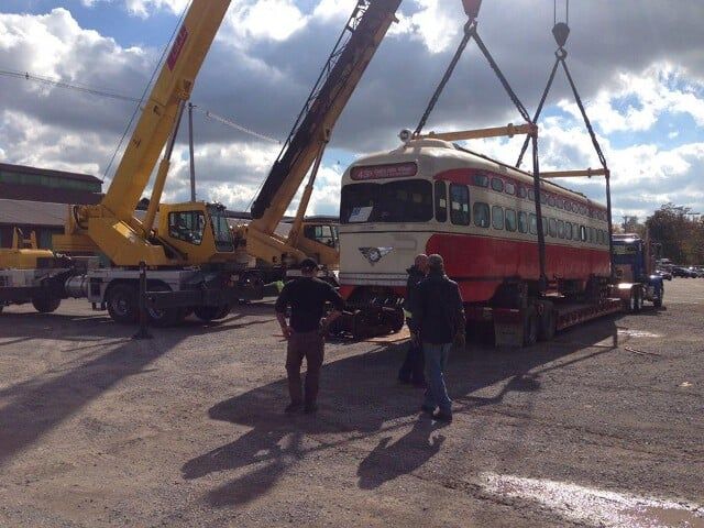 Red Trolley Car Lifted by a Crane - Constructions in New Castle, PA