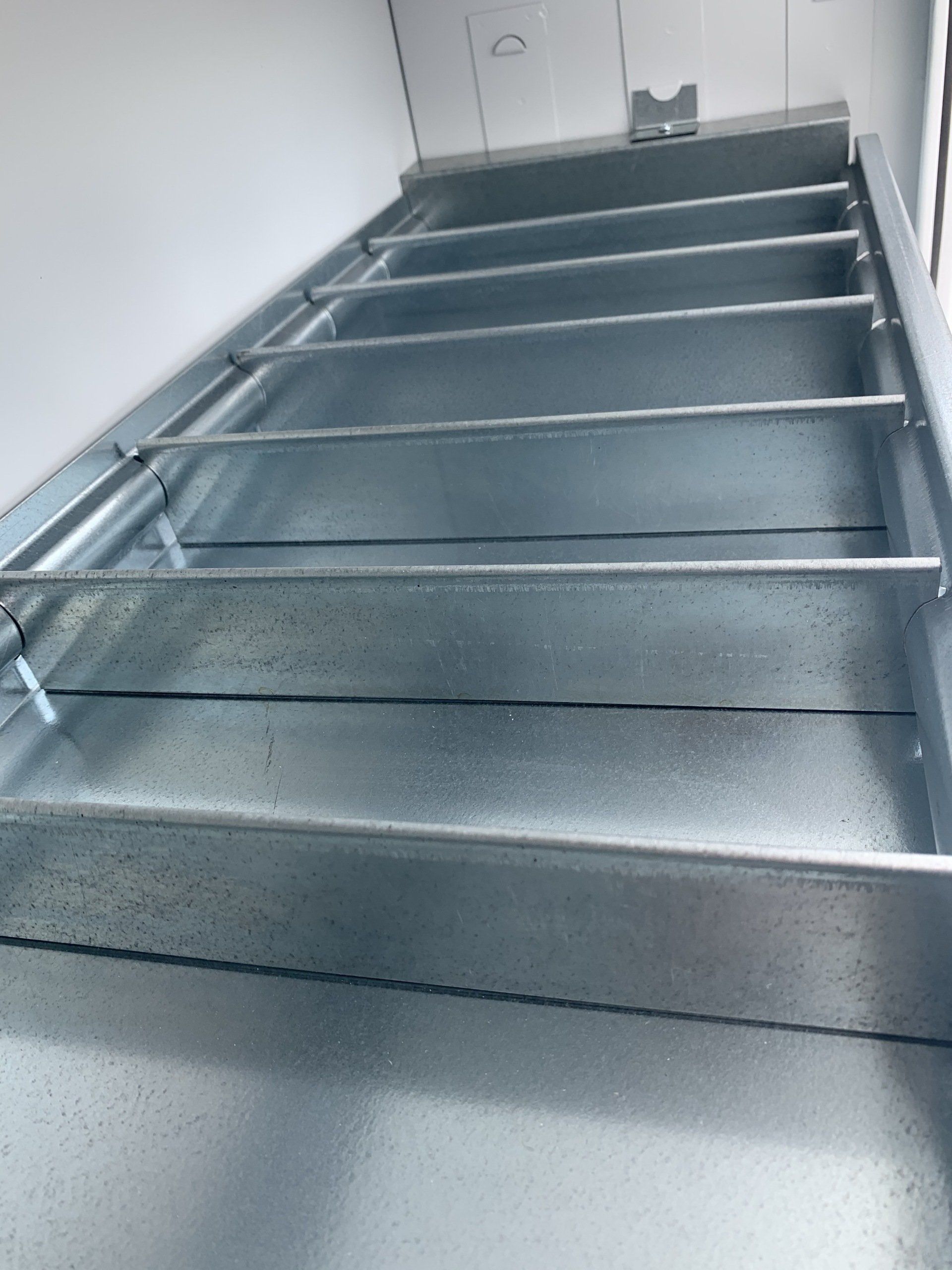 Metal staircase leading upwards, with steps in a silver, industrial style.