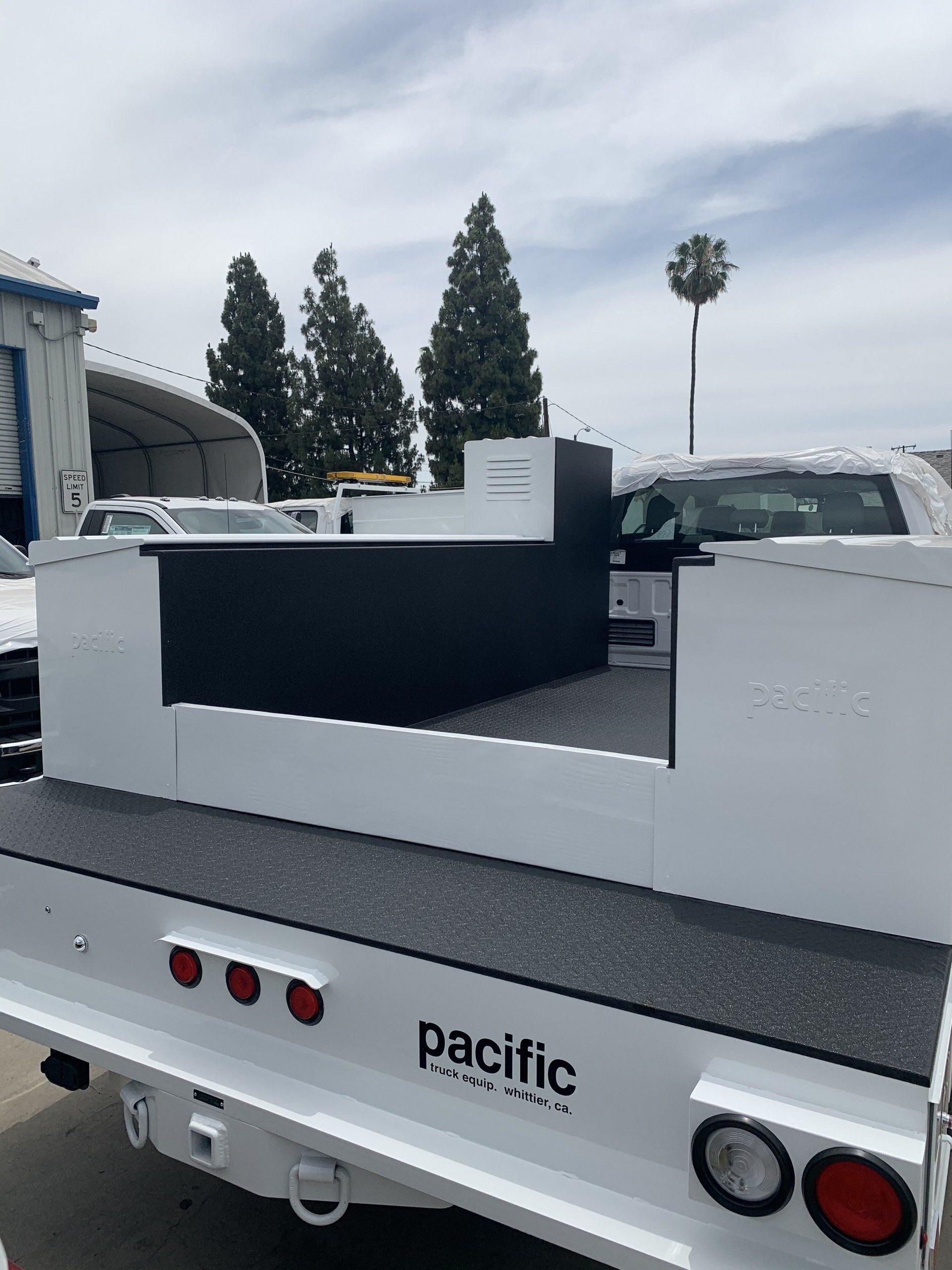 White utility truck bed with black storage.