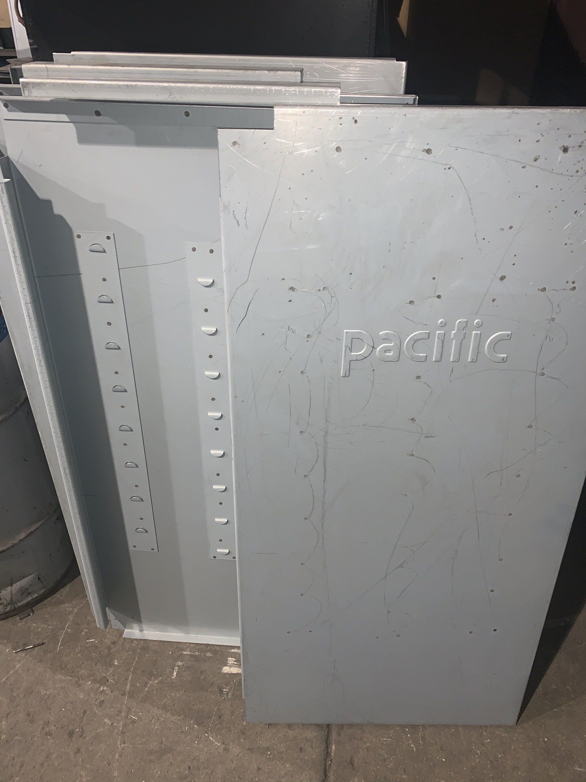 Gray metal panels stacked; one panel has