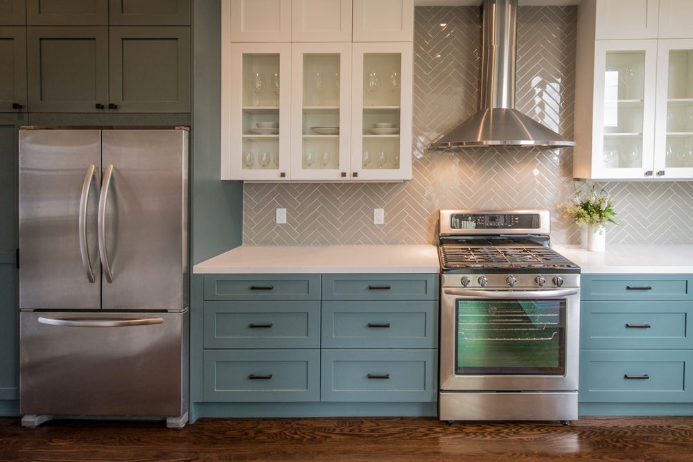 a kitchen with stainless steel appliances and blue cabinets