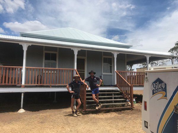 Mark & Brayden in front of house