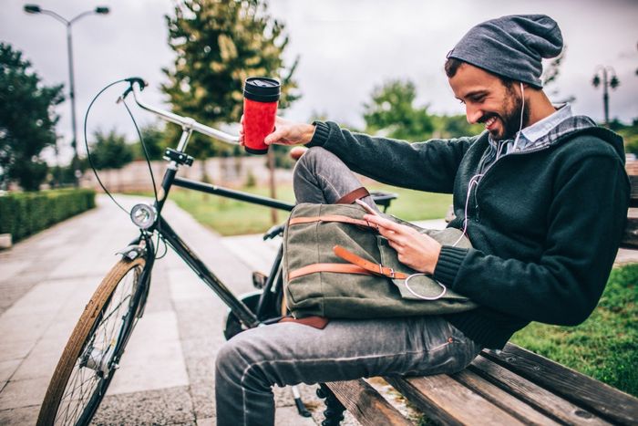 man sitting on bench with bike in Fort Collins, CO