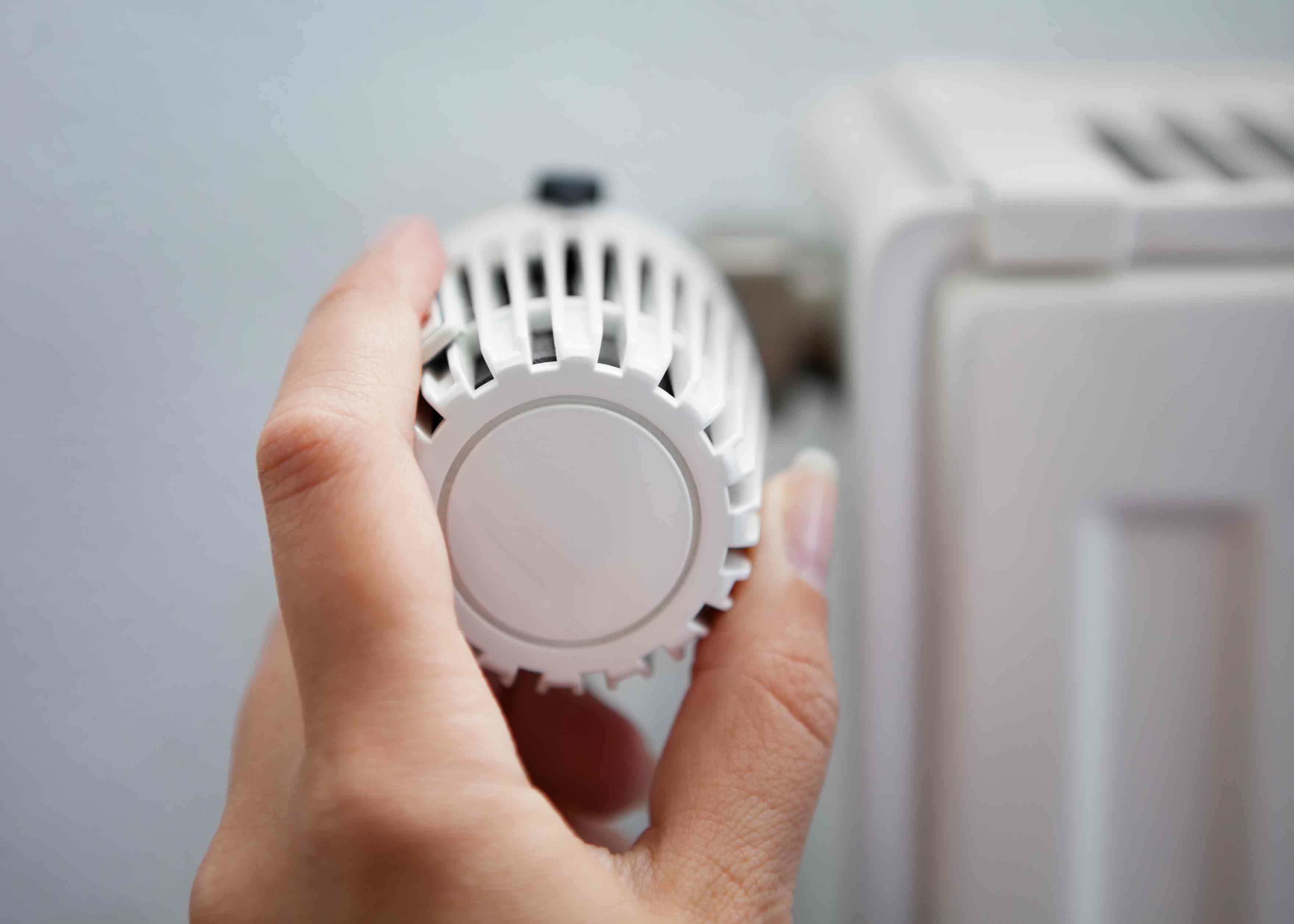 woman changing thermostat