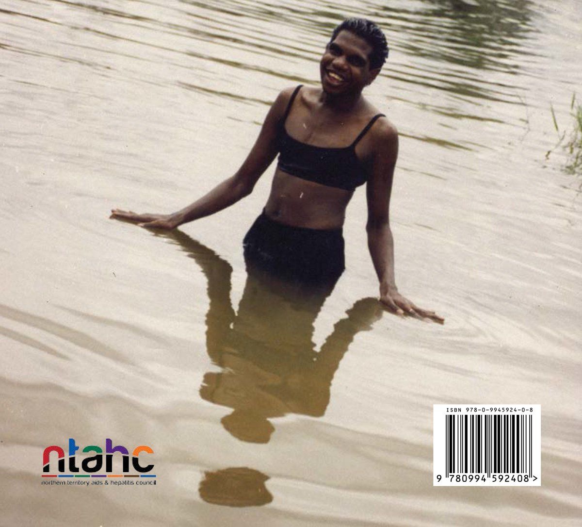 A woman in a bikini is standing in a body of water