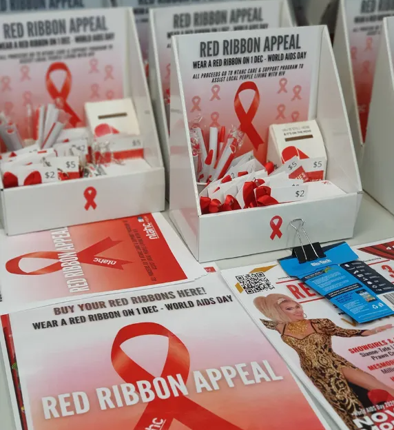 Several boxes of red ribbon appeal items are on a table