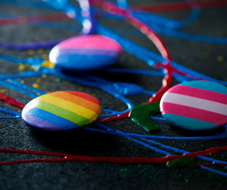 A bunch of rainbow colored buttons are sitting on a table