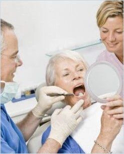 Patient Looking at Her Teeth — Medicaid in Yakima, WA Patient Looking at Her Teeth — Medicaid in Yakima, WA