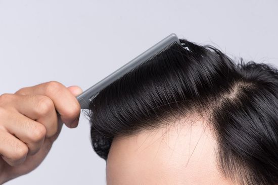 man combing his hairs
