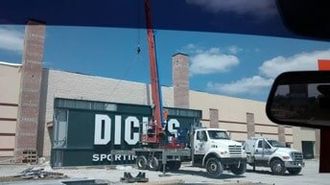 Truck Lifting Sign For Installation — Sign Fabrication in Jackson County, KY Truck Lifting Sign For Installation — Sign Fabrication in Jackson County, KY