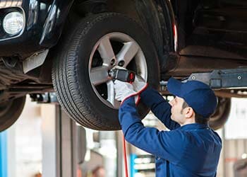 Mechanic Replacing Wheel — Auto Repair in Brentwood, TN Mechanic Replacing Wheel — Auto Repair in Brentwood, TN