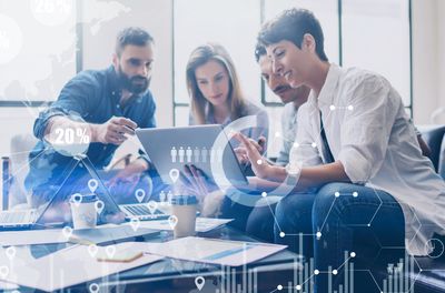 Concept of digital diagram,graph interfaces,virtual screen,connections icon on blurred background.Coworking team at business meeting.Group of colleagues working with startup project in modern office