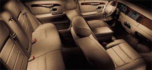 Beige leather interior of a car, including seats, dashboard, and steering wheel.