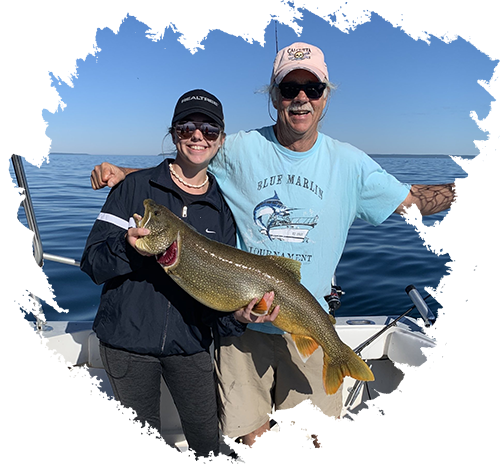 captain and a lady holding fish