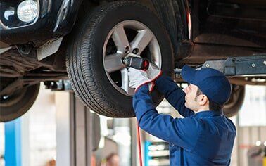 Mechanic Replacing Wheel - Auto Repair in Erie, Pennsylvania Mechanic Replacing Wheel - Auto Repair in Erie, Pennsylvania