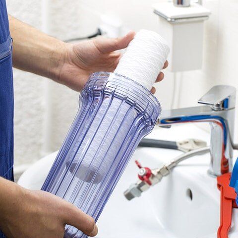 Plumber Installing New Water Filtration System — Water Filtration in Bundaberg, QLD Plumber Installing New Water Filtration System — Water Filtration in Bundaberg, QLD