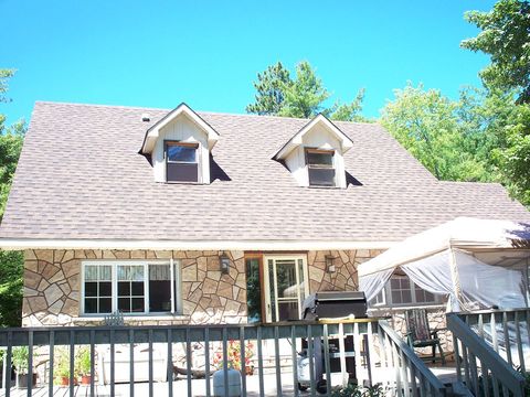 brick house with brown gable roof and dormer windows