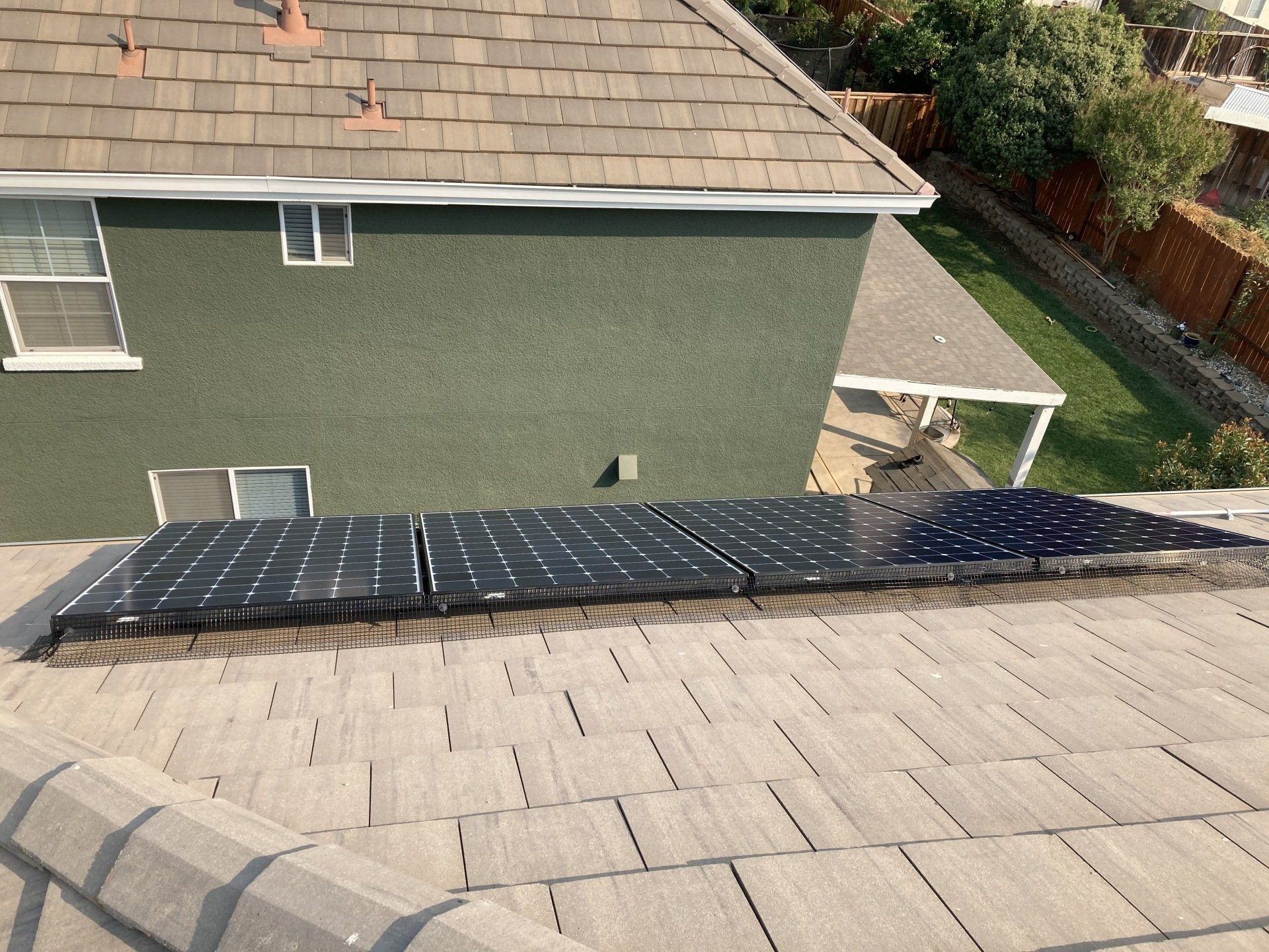 A row of solar panels on the roof of a house