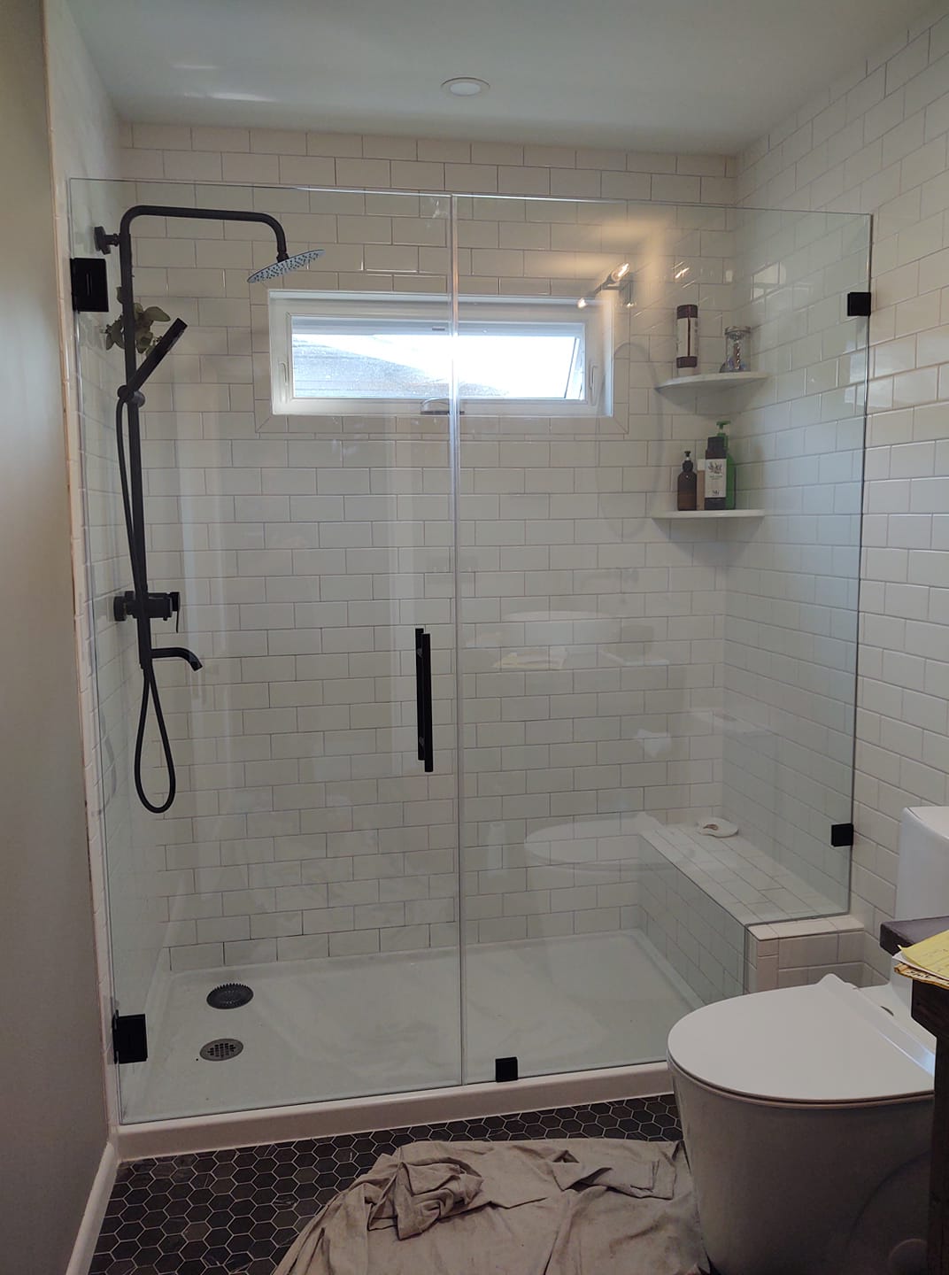 Frameless Shower Door and Black Bathroom Fixtures