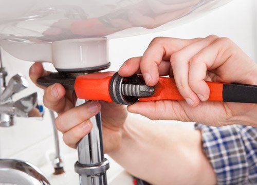 Idraulico che ripara il tubo del lavandino nel bagno