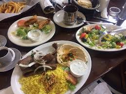 a table topped with plates of food and a cup of coffee .