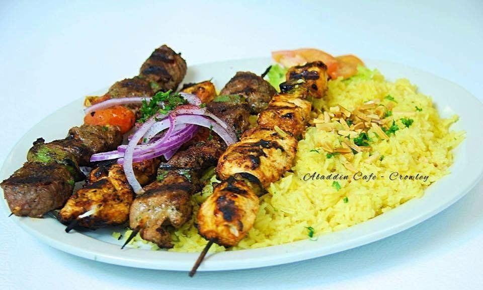 a plate of food with rice and meat on a table