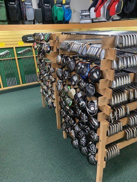 Rack of pre-owned golf clubs