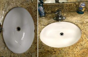 Two oval-shaped white bathroom sinks. The one on the right has a faucet and soap. Both are set in a speckled countertop.
