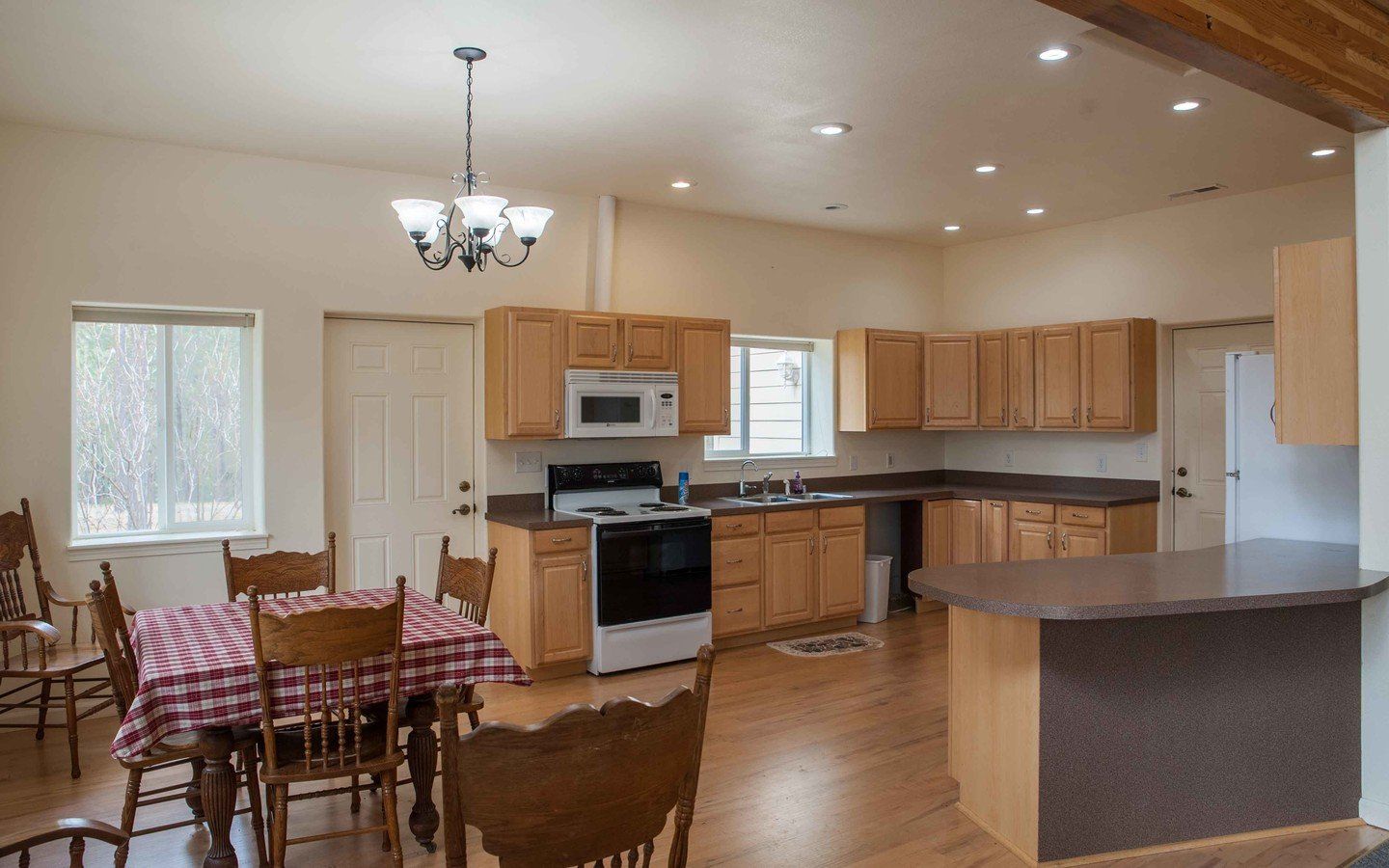 A kitchen with a table and chairs in it