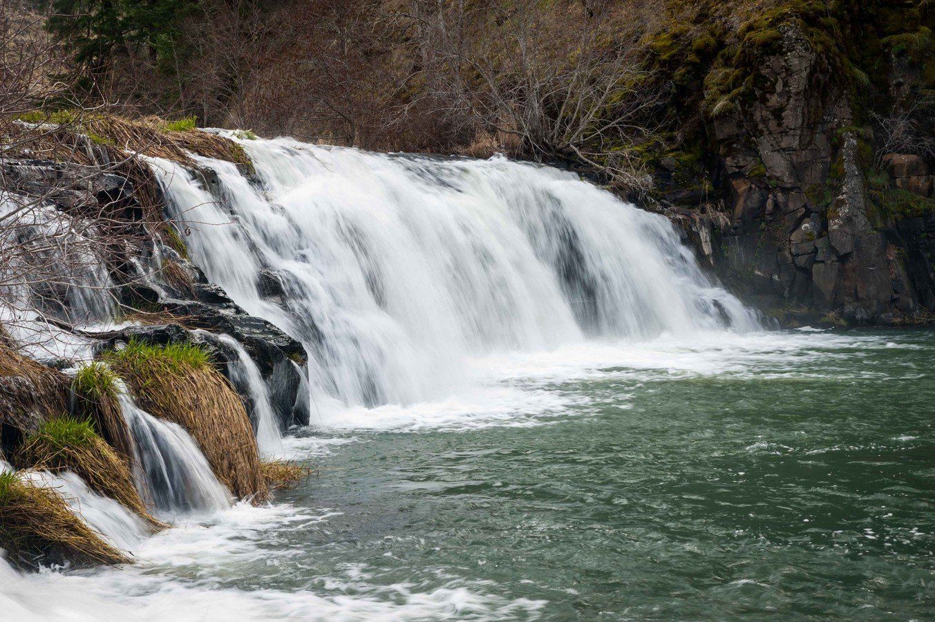 There is a waterfall in the middle of a river.