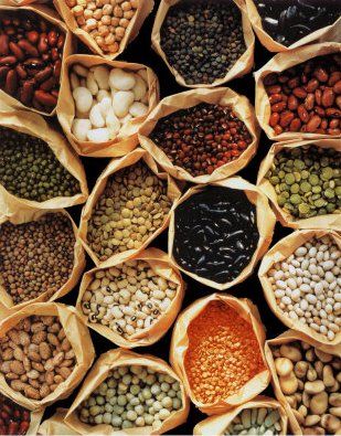 A bunch of bags filled with different types of beans