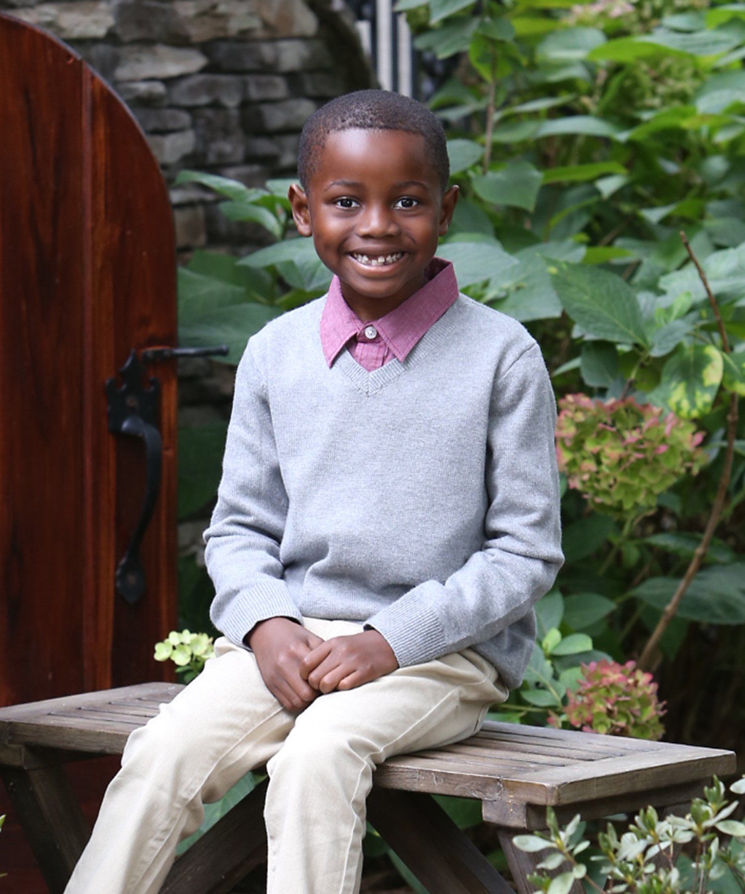 Outdoor portrait of young boy in garden