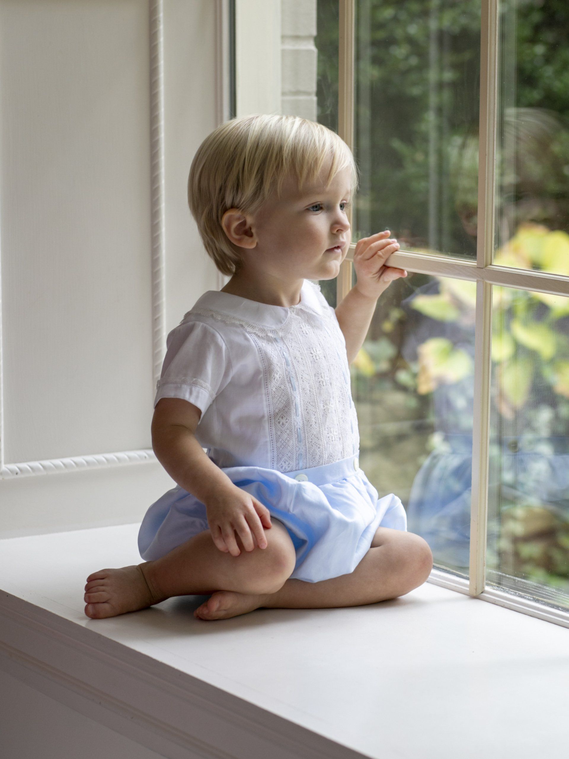Cute photo of boy looking out window