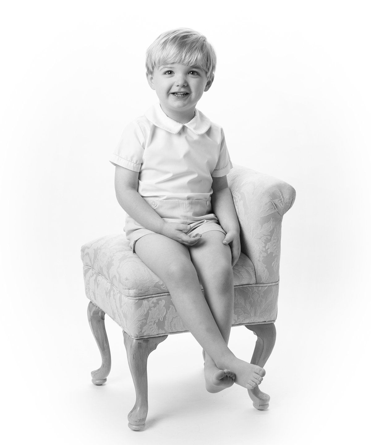 Black and white photo of boy in chair by Nashville photographer