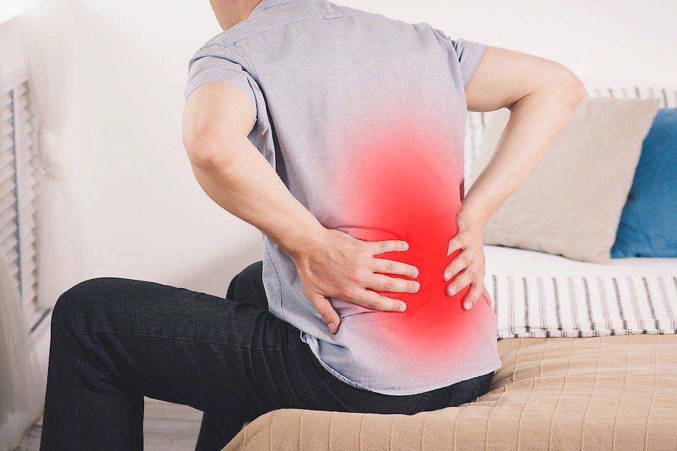 Spinal Pain Photo Man Holding Back 