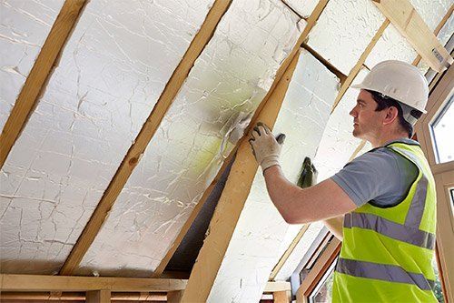 Builder Fitting Insulation Into Roof — Travelers Rest, SC — Guy M Beaty Co