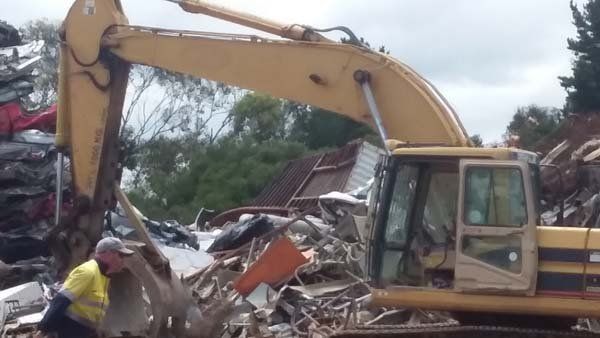 excavator next to trash