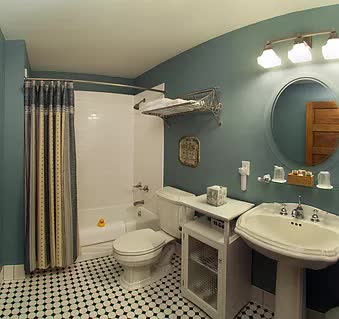 A bathroom with a toilet , sink , and bathtub.