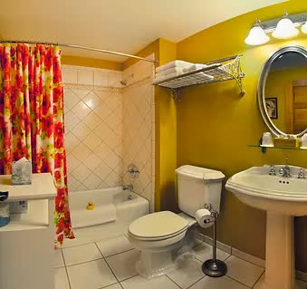 A bathroom with a toilet , sink and bathtub