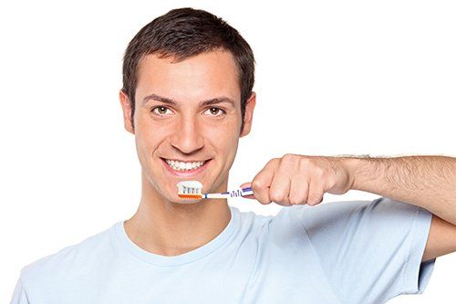 person brushing his teeth