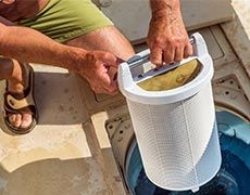 Spas —Man Pulling Out Pool Filter in South Lake Tahoe, CA Spas —Man Pulling Out Pool Filter in South Lake Tahoe, CA