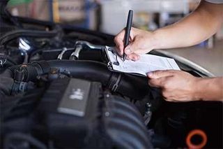 Mechanic repairman inspecting car — Full service auto repair shop in Bellingham, WA Mechanic repairman inspecting car — Full service auto repair shop in Bellingham, WA