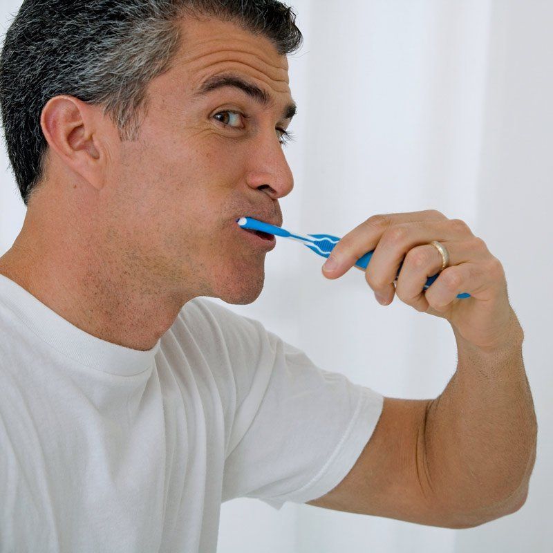 man brushing his teeth