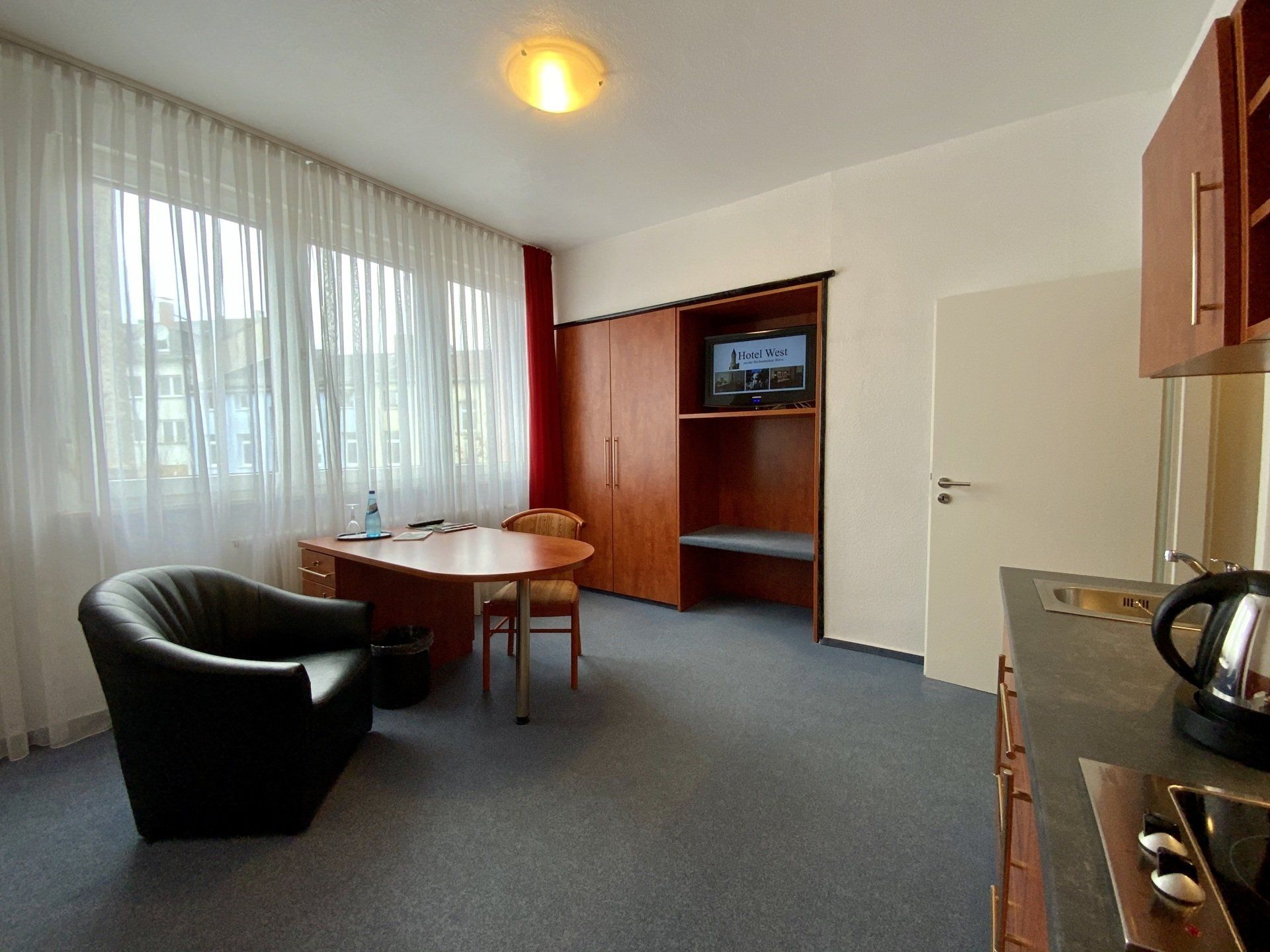 A living room with a chair a table and a television
