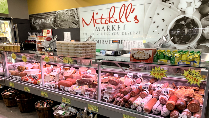 Mitchell's Market delicious deli a grocery store filled with lots of meats and vegetables.