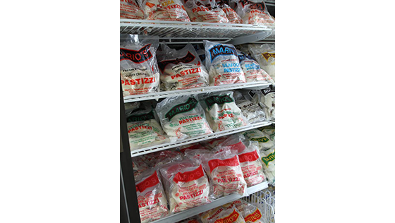 A refrigerator filled with bags of frozen food.
