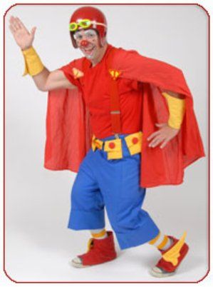 A clown dressed as a superhero with a red cape