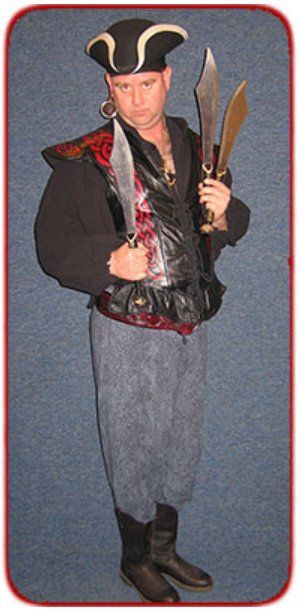 A man in a pirate costume is holding two swords