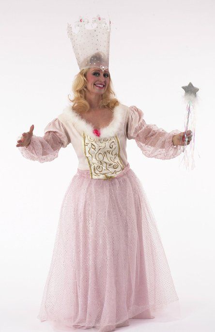 A woman in a pink dress and crown is holding a wand.